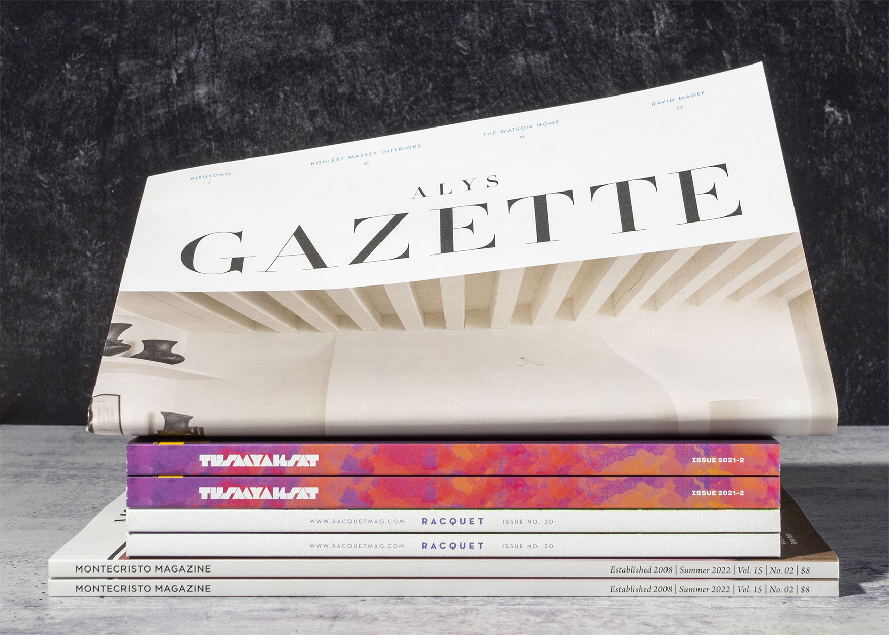 a stack of magazines with different binding styles and sizes.