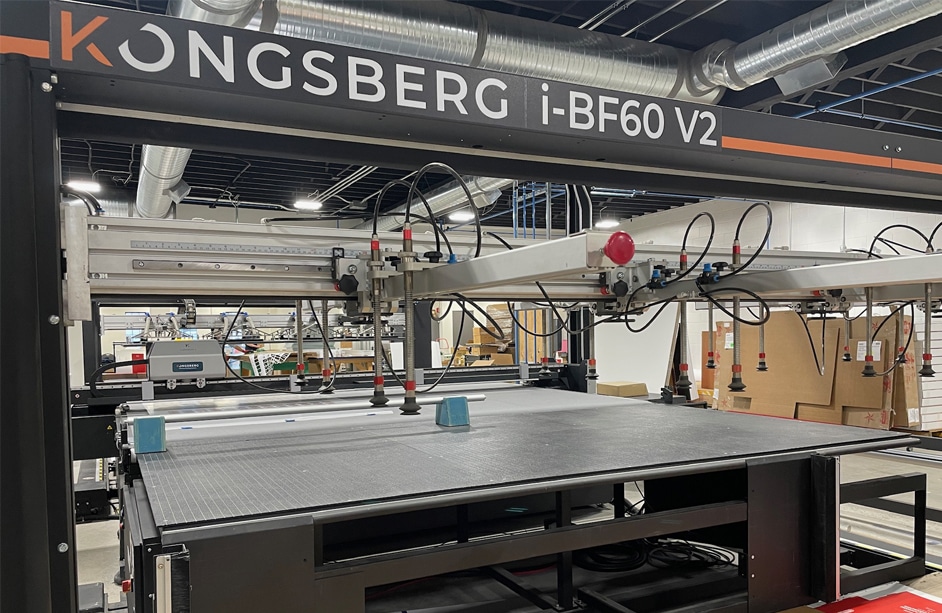 View from the end of the Kongsberg C64 digital cutter with i-BF60 V2 automated feeder and stacker