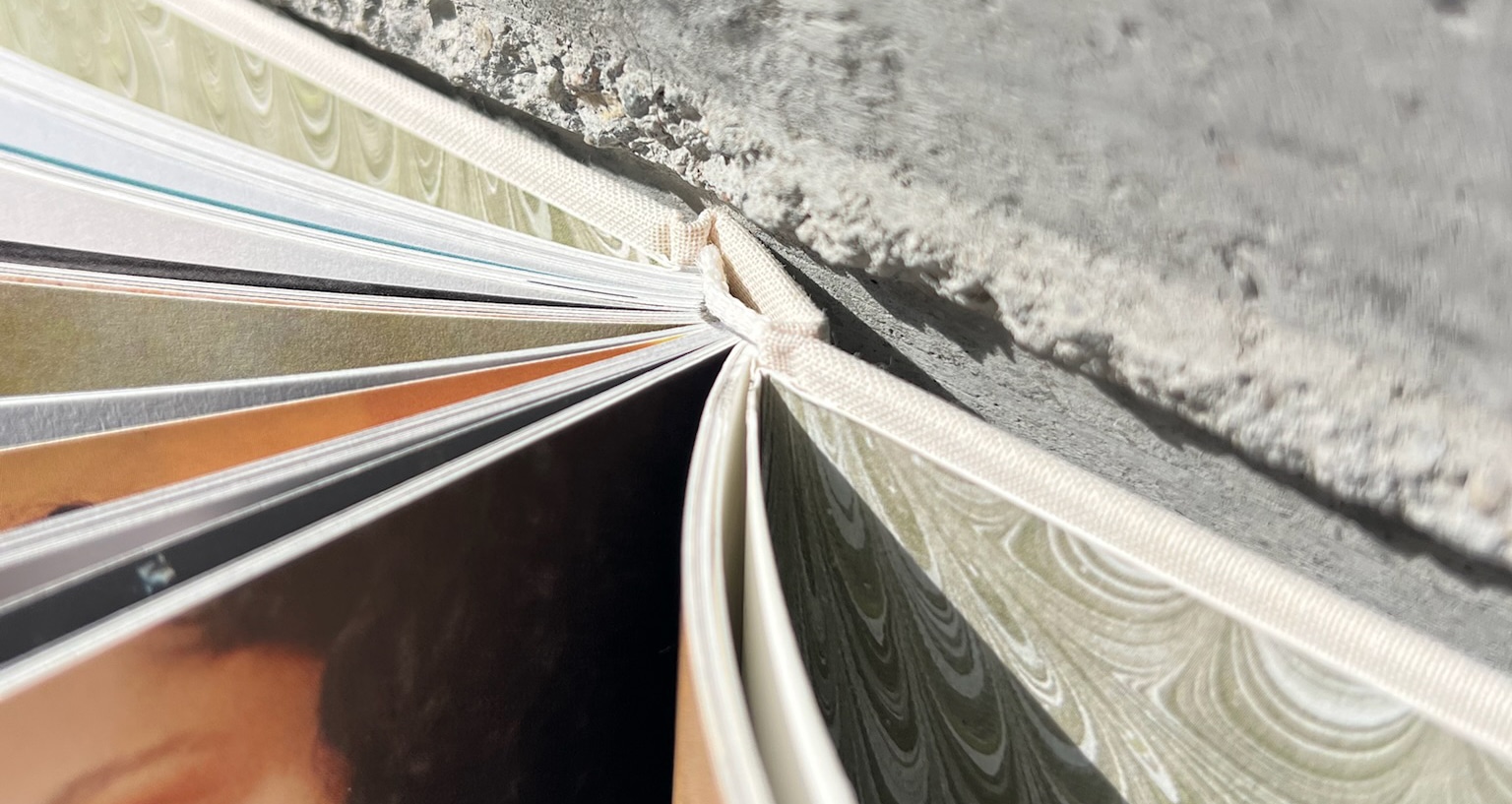 An angled view showing an open book from the top with the focus on the spine.