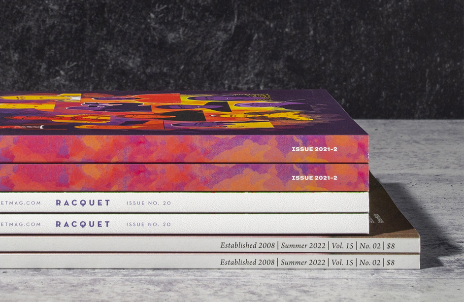 Close-up view of the aligned spines on a stack of perfect bound books.